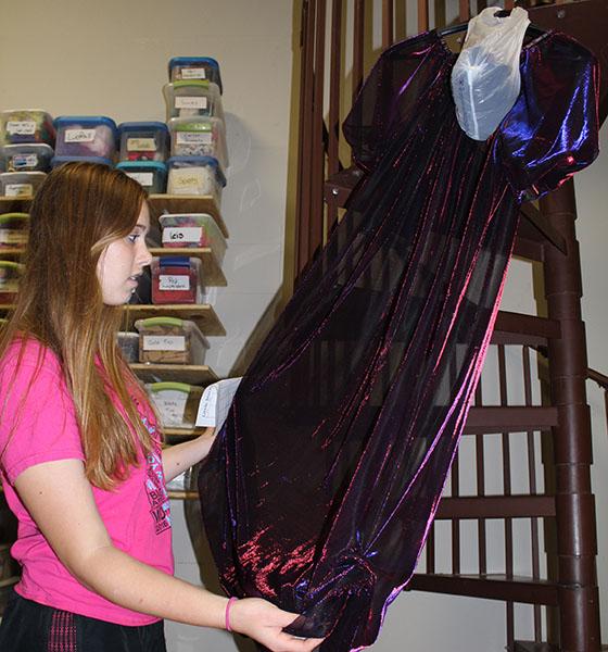 Amber Cook (10) examines a dress to see if it could be used for the musical.