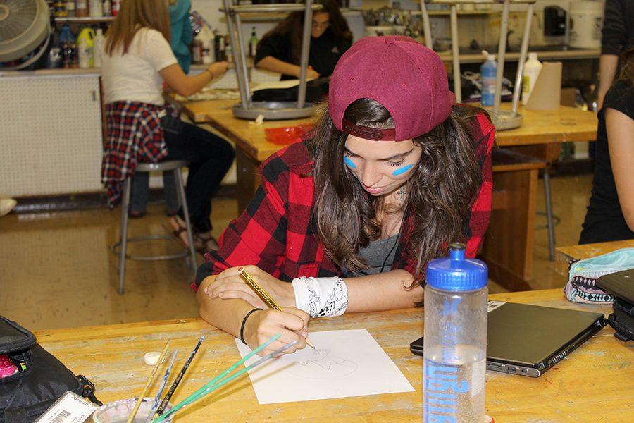 Participating in America Monday, Paula Rodriguez (11), creates a drawing. 