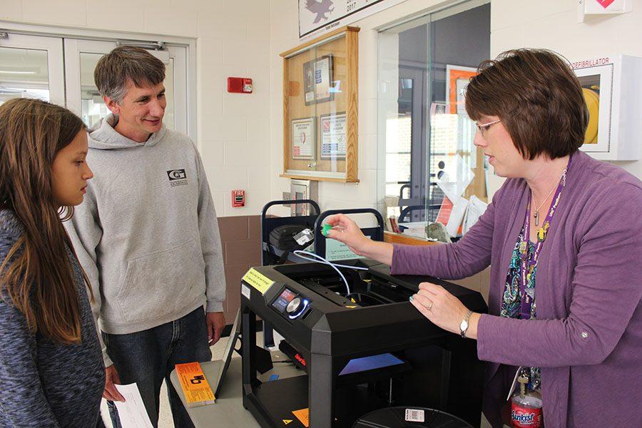 Showing interested parents and students the 3D printer, teacher librarian Stephanie Stocks promotes the new technology.