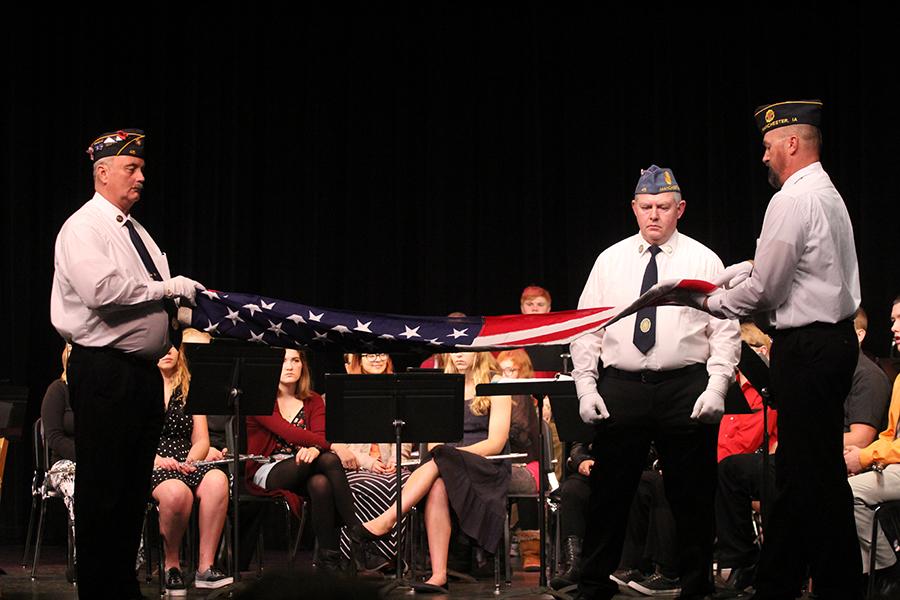 At the Veterans Day assembly in the Hanson Auditorium veterans demonstrate the flag folding ceremony.