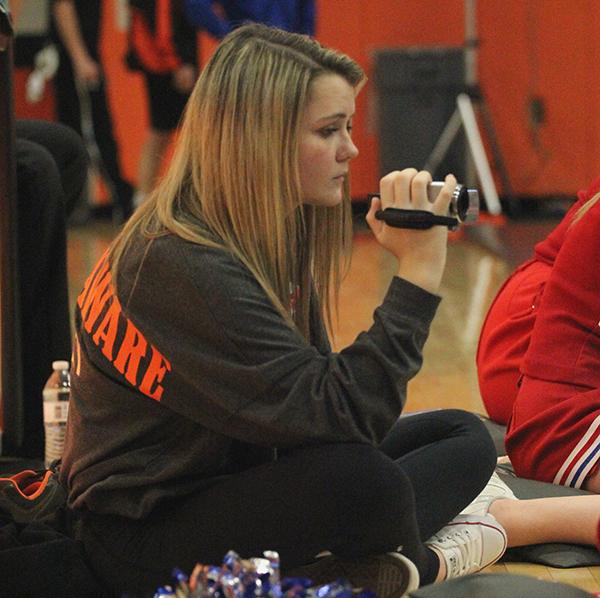 Freshman Isabelle Willey videotapes Cole Engel during the Bob Murphy Invitational. Willey became an administrative assistant this year. 
