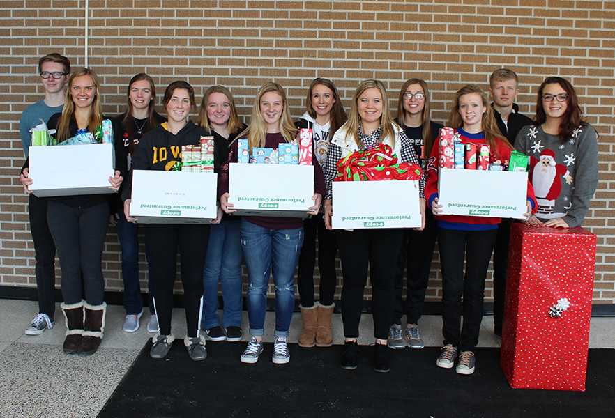 Members of NHS who adopted a family stand with the presents they bought. Pictured left to right is Holden Smith (11), Kara Hawker (12), Katie Steffan (12), Rachel Haight (11), Bryonna Rodgers (11), Kelly Scherbring (11), Macy Klein (12), Kenna Coates (12), Emma Kehrli (12), Emily LaRosa (11), Ben Litterer (11), and Annie Cassutt (12).