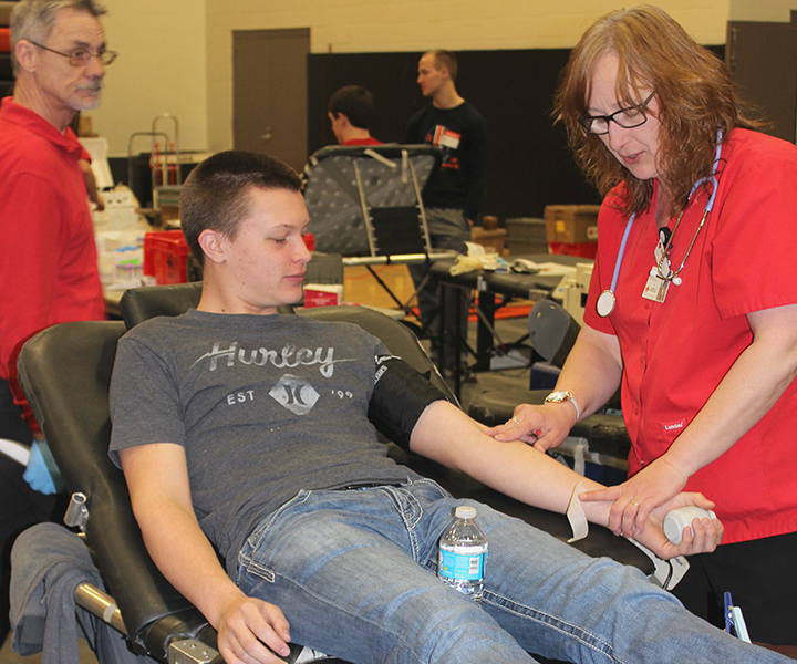 During the blood drive, Trent Shaw (12) helps save two lives by giving blood. 