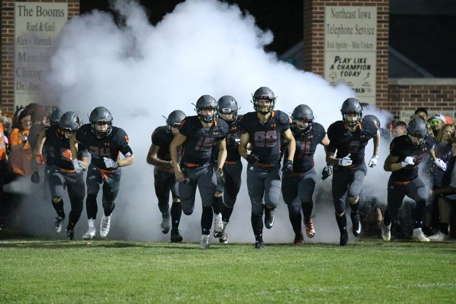 Before the homecoming game the varsity team enters the field. “You know its gametime when youre running through that smoke,” senior Harrison Goebel said. 