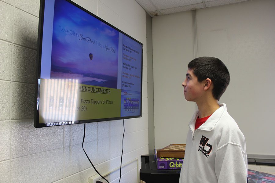 Sophomore Matthew Salas checks the announcements for new information while in the library. The new TV sets allows students like Salas to revisit the announcements without opening an electronic device. 
