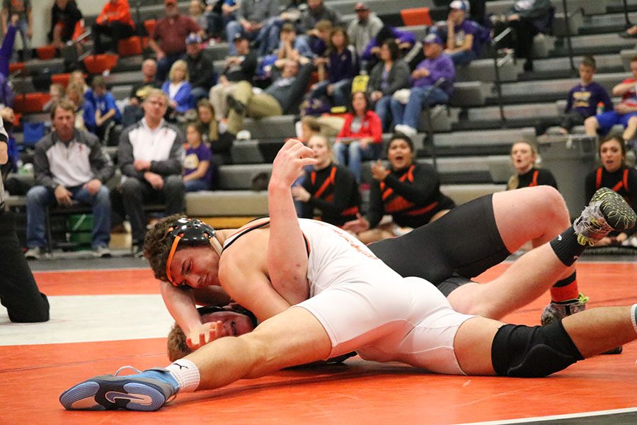  In his finals match against Davenport Assumption’s Seth Adrian, senior Harrison Goebel puts the final touches on a pin. Goebel finished each of his matches with pins in the first period.
