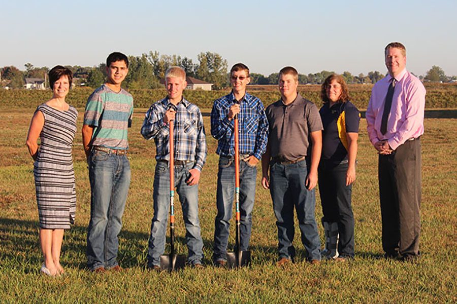 Superintendent Dr. Kristen Ricky and Principal Tim Felderman look on as FFA advisor Tammy Schneiders and her students begin construction for their future barn on Sept. 29. From left to right: Ricky, Nathan Bishop (11), Jacob Kaiser (11), Josh Hilby (12), Kyle Steffen (11), Schneiders and Felderman. 
