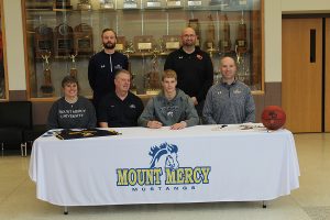 Tyler Kelley (12) signs to play basketball for Mount Mercy University next year. 