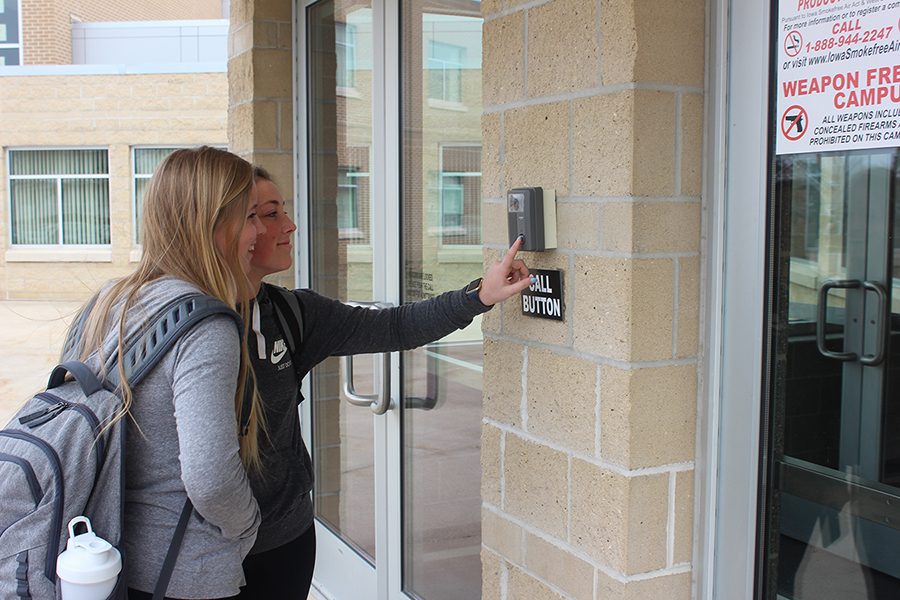 Seniors Kira Vaske and Rachel Haight use the buzzer to be let in during the school day.