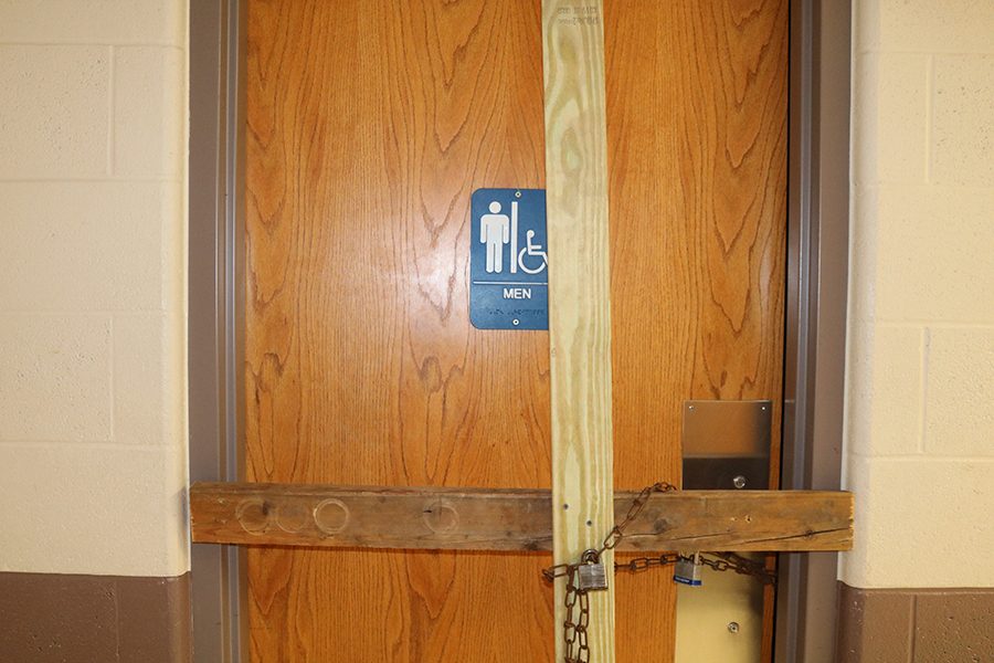 Locking+the+boys+bathroom+with+boards+and+chains%2C+Principal+Tim+Felderman+stops+the+vandalism.+