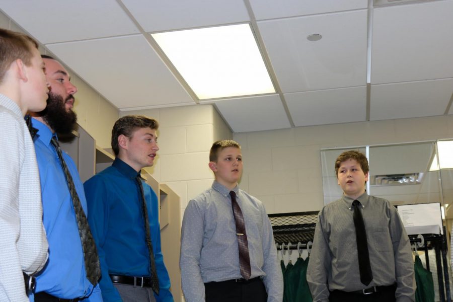 Before their performance at the rescheduled State Solo/Small Ensemble Festival, a mens ensemble practices.