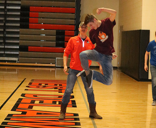 While having fun at Speech Game Night, Tyler Salow (11) celebrates with a heel-click.
