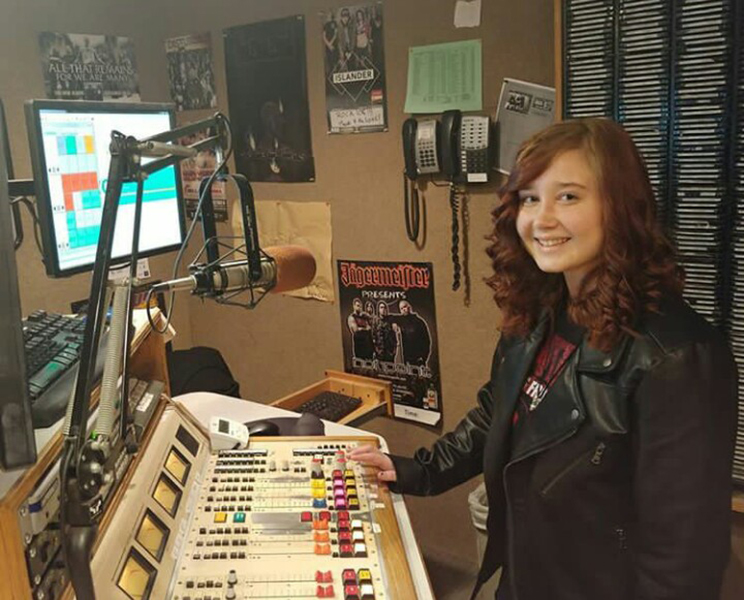 Kyli Hass (12) messes around with the sound board in the ROCK 108 studio.