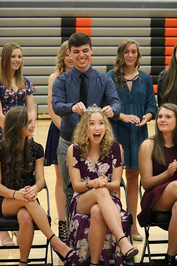 Homecoming King Justin Grawe places the crown on Grace Reiss head, signifying her as the Homecoming Queen.