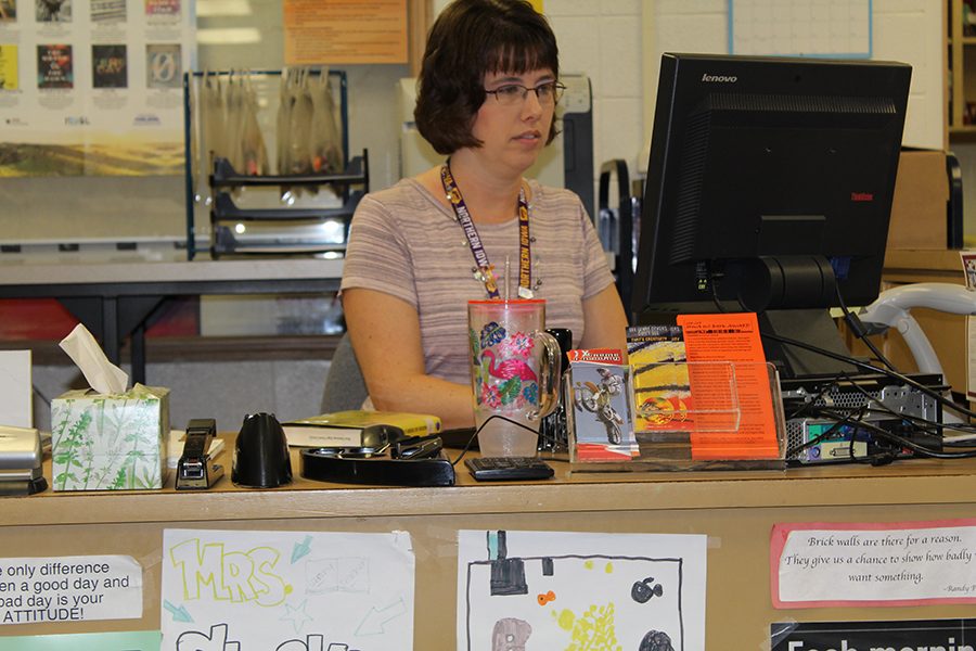 Stephanie Stocks sits at her desk in the library while she works. 