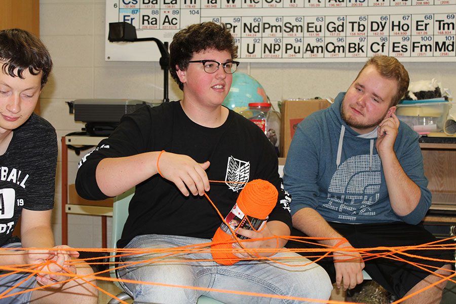 During a group activity in homeroom, junior Branddon Hoeger catches the ball of yarn to answer a question from a fellow classmate. 