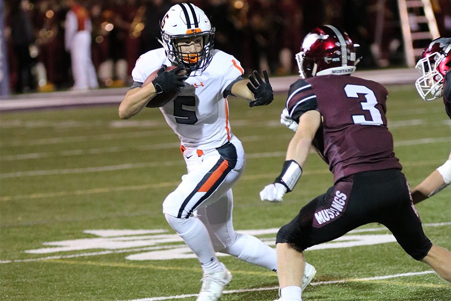 Senior Mitchel Mangold runs the ball down the field against the Mount Vernon defender.