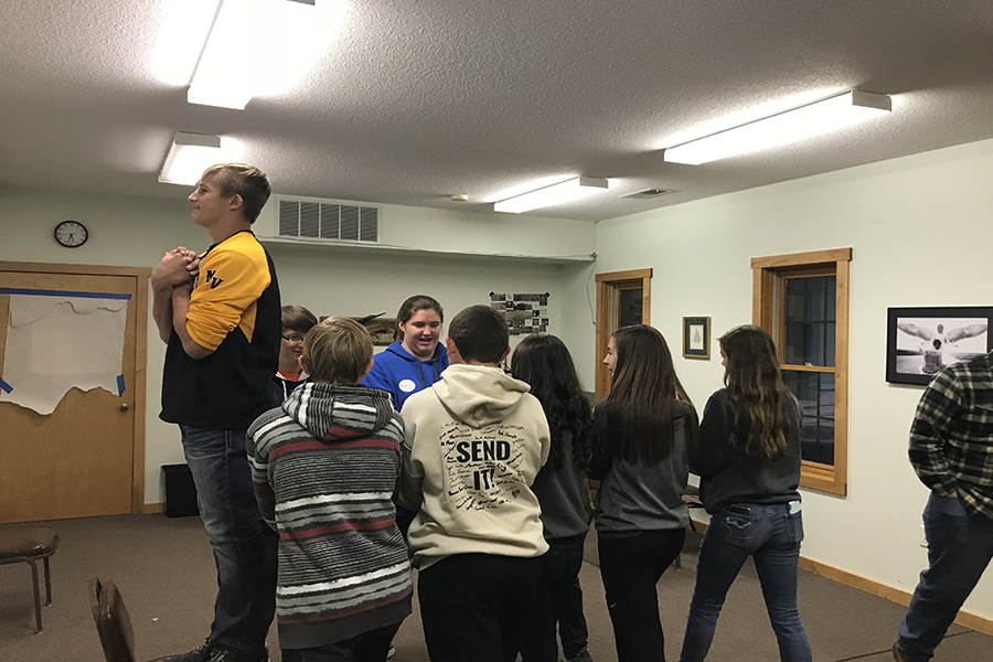 A Mount Vernon student prepares to fall back into the arms of other Mount Vernon and Maquoketa Valley students along with West Delaware students Kyleigh Marsden (10), Murphy Oakleaf (10), Ian Rogers (10) and Peyton Hass (10) during a trust fall. Students from schools around Iowa came to Camp Ewalu for Youth Leadership day and participated in various events.