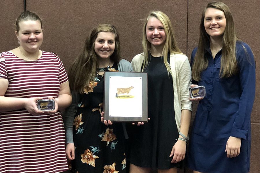 When given their award for high team in Jerseys, Madi Palmer (10), Amber Engelken (11), Laney Demmer (10), and Tehya Demmer (12), pose for a picture with their plaques. The girls worked as a group of four during the competition.