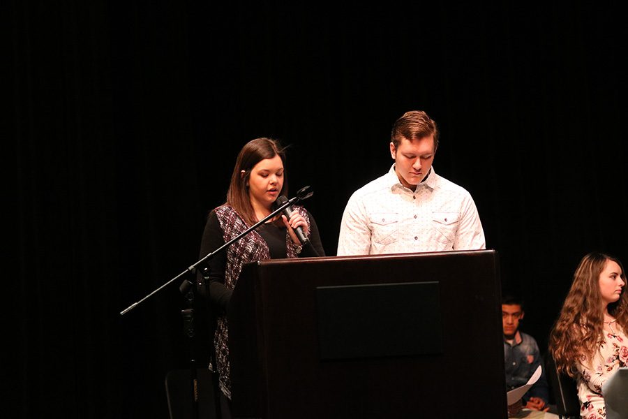 Parker Ostrander and Kennedy Niles start the assembly with the Pledge of Allegiance.