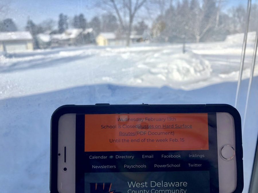 A phone displaying the message that school is closed Feb. 13, due to bad road conditions. 