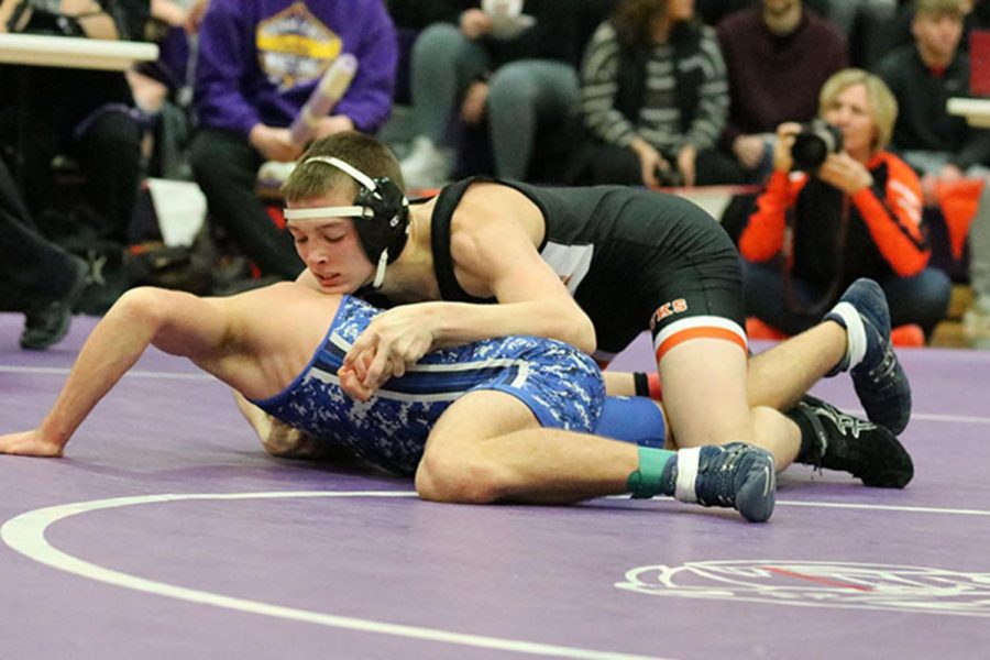 Freshman Jayden Peyton works to pin an Anamosa wrestler at the district tournament. Peyton placed second in the tournament and qualified for state. 
