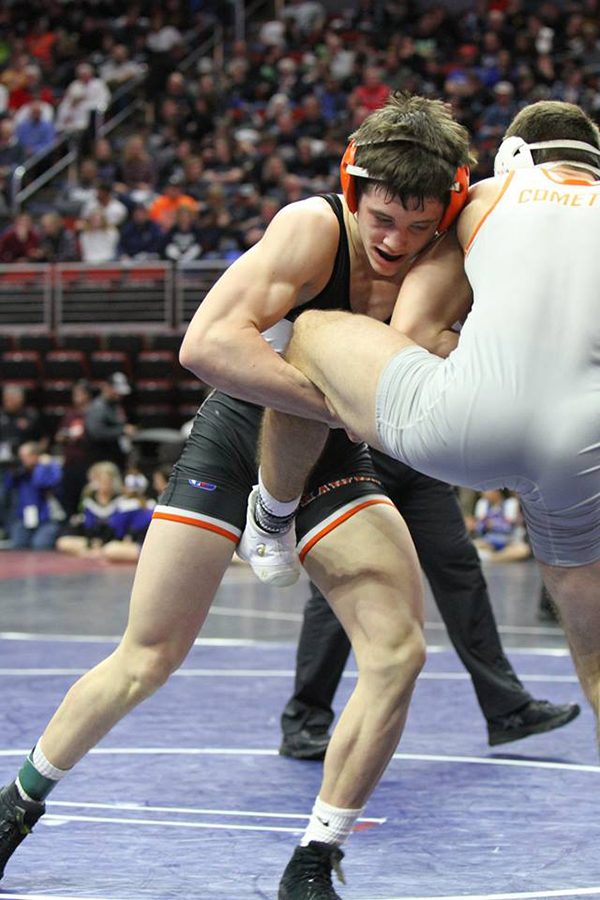  Freshman Wyatt Voelker works to takedown his opponent during the state traditional tournament in Wells Fargo Arena. Voelker scored 12 points during the traditional tournament.
