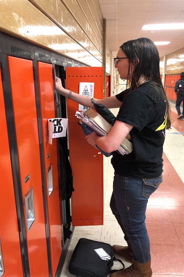 Junior Kamille Hawker stops by her locker in the morning before first hour to switch out her school materials.