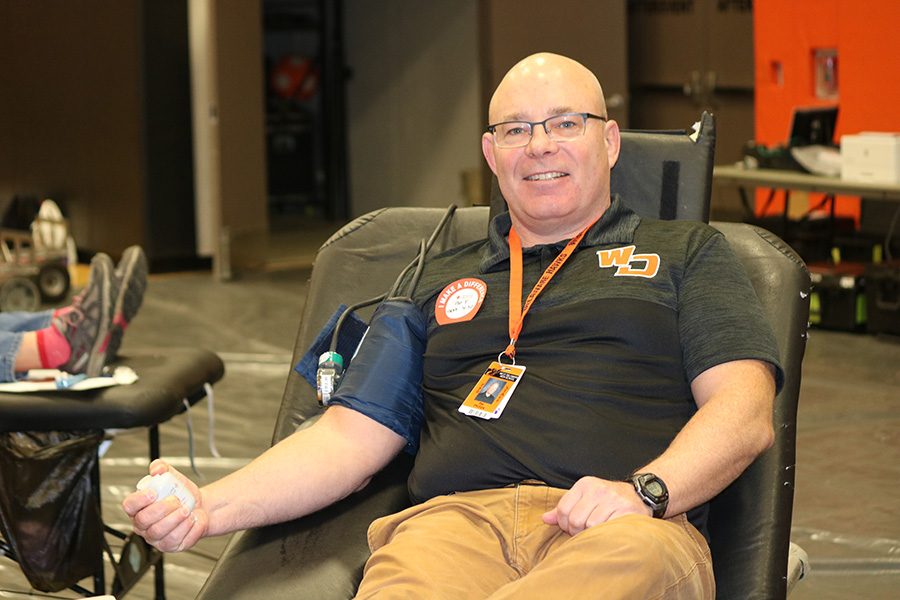 Teacher+Pat+Phillips+donates+blood+during+the+previous+blood+drive+in+November+2018.