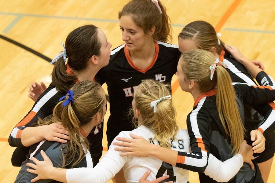 Captain Macey Kleitsch (12), Kayla Felton (10), Sydney Morris (12), captain Ella Koloc (10), Carlee Smith (10), and captain Allison Collier (12) discuss their strategy for their next play during their game against Williamsburg.