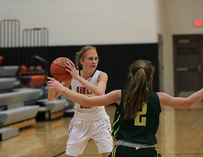 Looking for an open teammate, Alivia Schulte (9) hopes to pass the ball. The Hawks lost to Beckman, 50-68. 