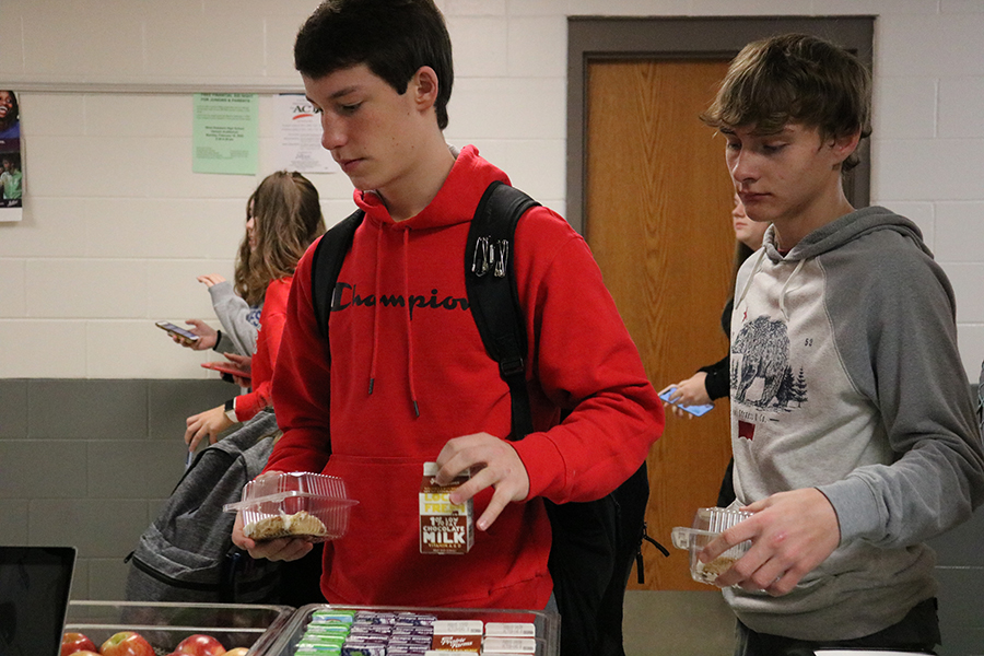 As students line up, freshmen Grant Northburg and Kaden Ryan try the second chance breakfast.