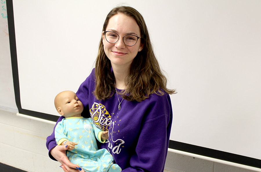 Hannah Recker (11) poses while holding her baby.