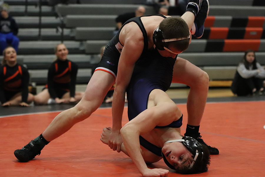Against Anamosa, 145-pounder Jadyn Peyton (10) attempts a pin over Sam Norris. Peyton won by fall at 3:07.