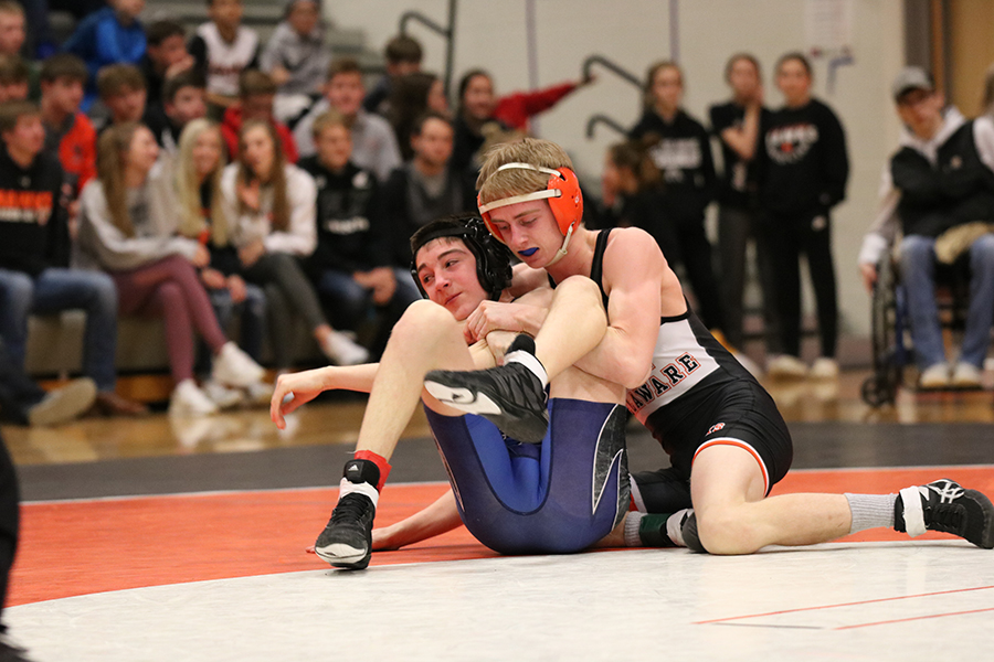 In the 113-pound match against Anamosa, Luke Farmer (12) puts Tyson Gravel in a cradle. Farmer won with a fall at 0:24.
