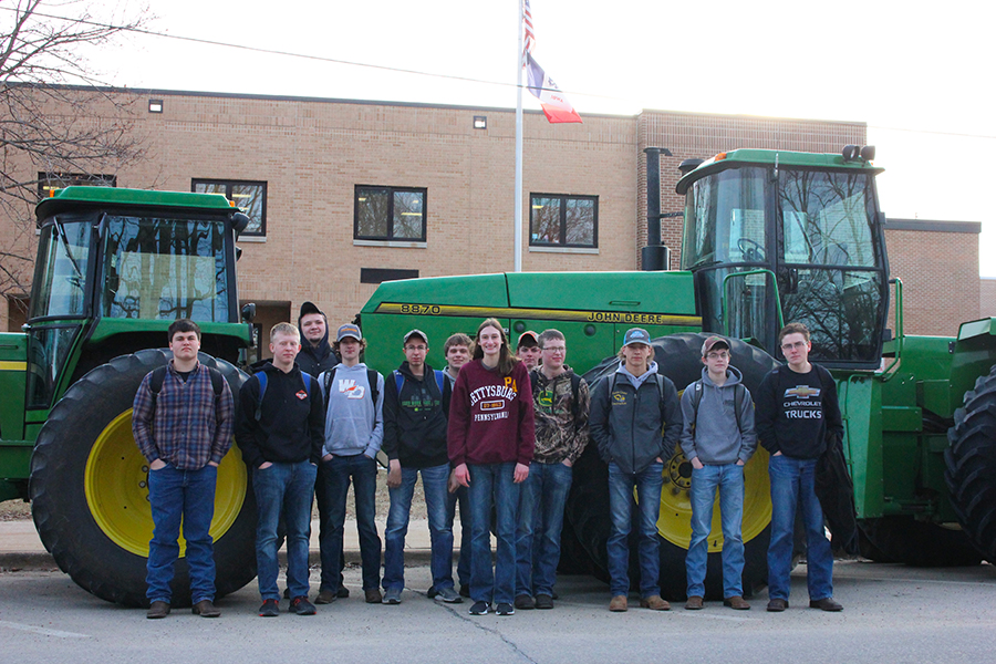 During FFA week, Mitchell McDonald (10), Phillip Ries (10), Mitchell Krogmann (11), Noah Jackson (10), Kyle Deutmeyer (11), Cody Monaghan (10), Lori Hilby (10), Blake Deutmeyer (10), Andrew Ries (10), Thomas Crane (10), Trent Deutmeyer (10) and Levi Mullis (12) pose in front of their tractors on Tractor Day. 