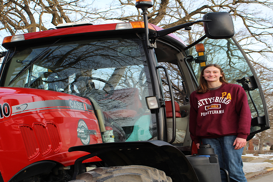 Lori Hilby (10) climbs down from her tractor after driving it to school.