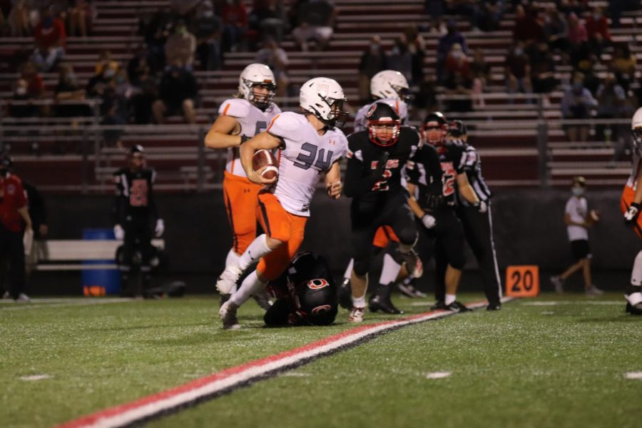 Wyatt Voelker dodges incoming tacklers on Friday night against Clinton to help win the game, 55 to 6.