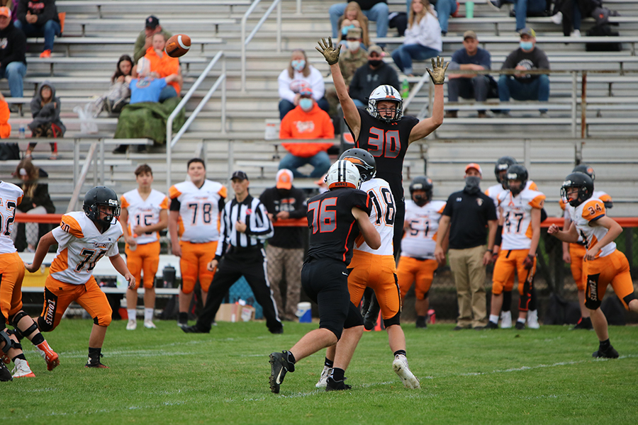 While attempting to block the pass from the Charles City quarterback, Cash Hauser (9) towers over his competition last Friday. The freshman and sophomore Hawks won their Homecoming game with a final score of 35-0.