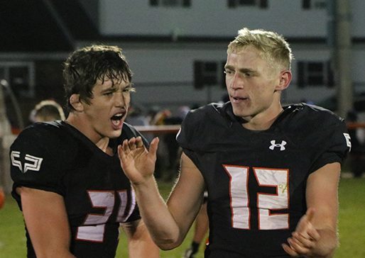 After winning their second playoff game and qualifying for state. Senior Jared Voss and Junior Wyatt Voelker celebrated together on Brown Field. 