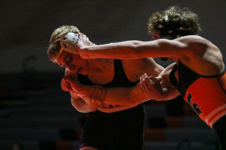 With his opponents arm tight to his chest, Jared Voss (12) attempts to get another take down to increase his lead. During this dual they wrestled Solon where they won in a blowout 68-7.