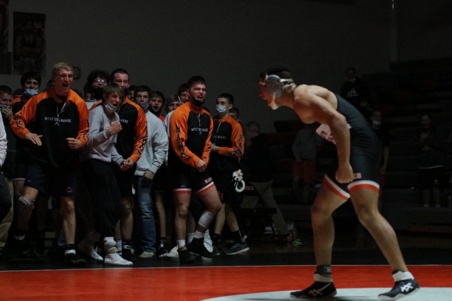 The+Hawk+wrestlers+celebrate+an+exciting+win+with+senior+wrestler+Christian+Nunley+as+he+pins+his+opponent+late+in+the+third+period.