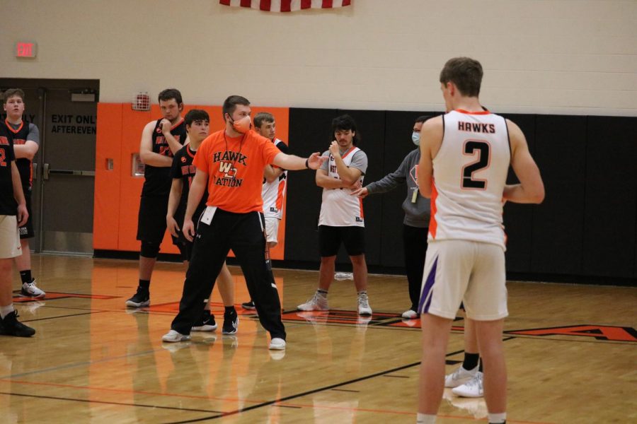 New Head Coach Drake Schuring walks the team through the drill. 