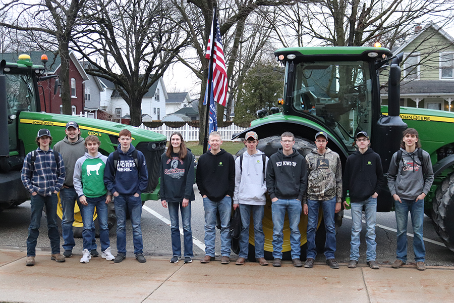 On Tractor Day, Noah Jackson (11), Mitch Krogmann (12), Kaden Ryan (10), John Beswick (9), Lori Hilby (11), Phillip Ries (11), Blake Deutmeyer (11), Andrew Ries (11), Kyle Deutmeyer (12), Trent Deutmeyer (10) and Landon Rausch (10) pose in front of Ryan and  Krogmanns tractors.