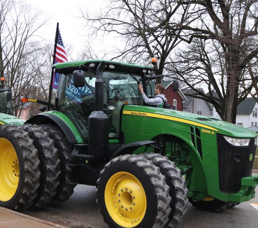 Kaden Ryan (10) exits his John Deere tractor. 