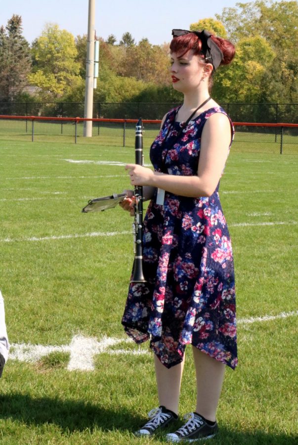On Brown Field during band class, Hallie Knutson (12) prepares to play Music of the Night while she dresses like a 1950s woman. On Thursday during Homecoming Week, students’ attire reflected a decade; hippies, flappers, and even a pilgrim roamed the hallways.