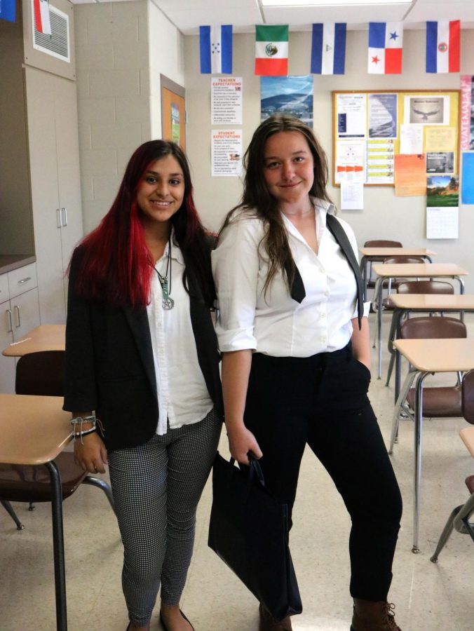 On Family Day, Alex Rattenborg (11) and Sydney Lorang (11) pause after Spanish III to show off their attire. With Rattenborg as a judge and Lorang as a lawyer, both students based their costumes on their mothers’ careers.
