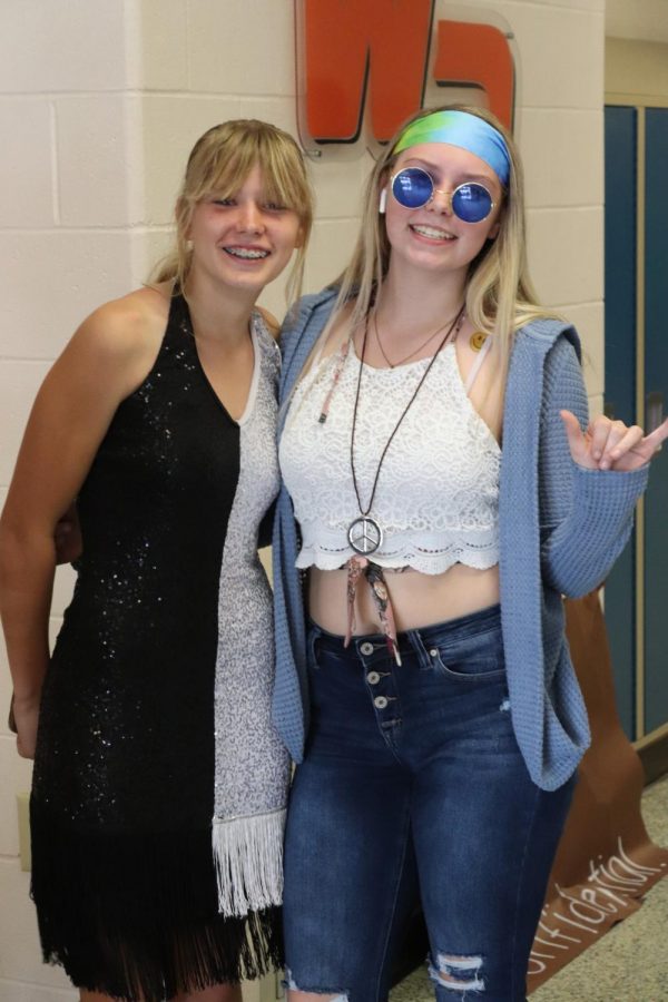 Cassidy Hack (10) and Kiley Kregel (12) pose for a photo on decade day. Hack dressed as a flapper girl from the 1920s; Kregel dressed in 1970s attire.
