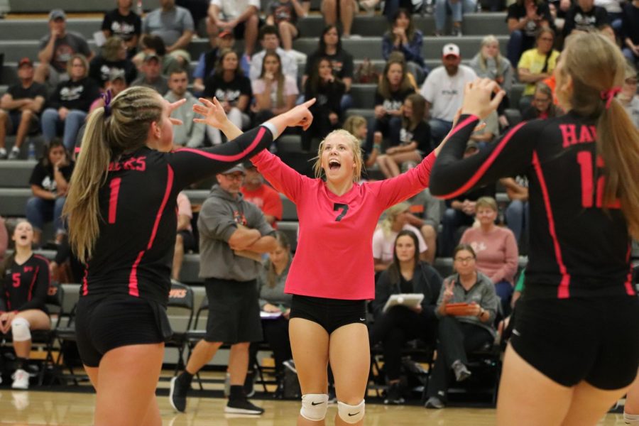 At the pink out game on Sept. 14 against Solon, senior Ella Koloc (4) cheers with senior Carlee Smith (1) and freshman Brooke Krogman (12)  after scoring a point.