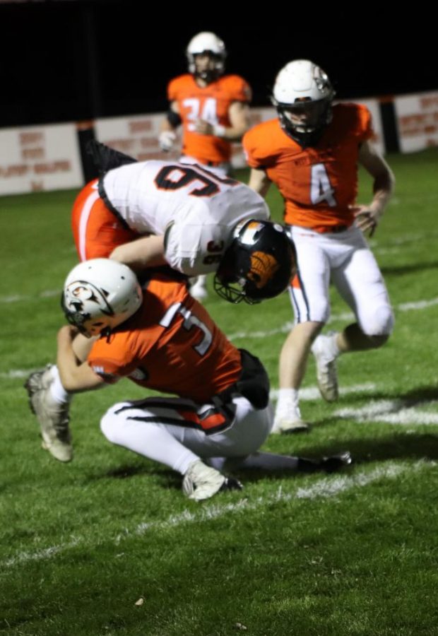 Senior Kyle Cole tackles Grinnells ball carrier Will Doty.